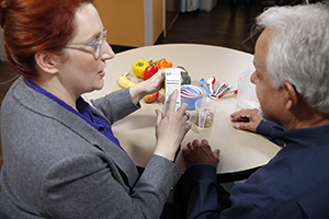 Health care provider showing patient nutrition label on food package.