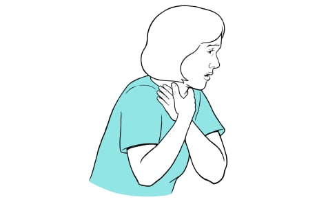 Woman holding hands to throat, looking distressed.