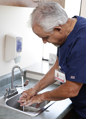 Health care provider washing hands.