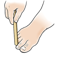 Hand with nail file filing down callus on toe.
