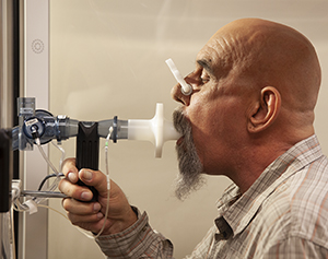Man having pulmonary function test with a spirometer.