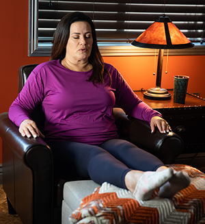 Woman relaxing in chair with feet up.