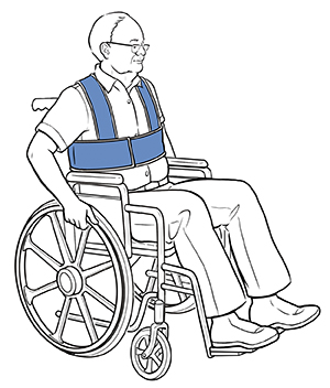 Man sitting in wheelchair with safety straps around waist and shoulders.