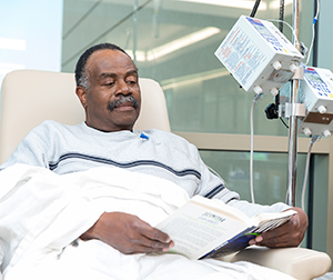 Man sitting in chair having infusion treatment.