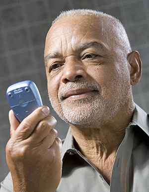 Man looking at glucose meter.