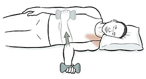 Man lying on side doing internal rotation shoulder exercise with hand weight. 