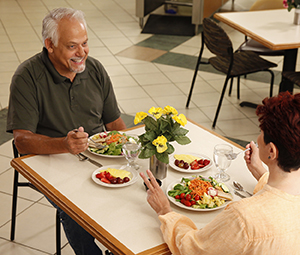 Two people eating healthy food in restaurant.