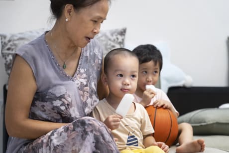 A parent looking after 2 small children.