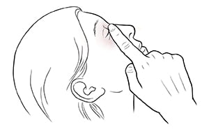 Woman leaning head back with closed eye, pressing finger between eye and nose.