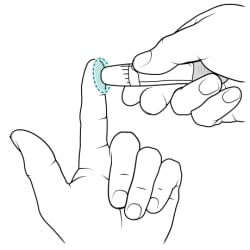 One hand holding lancet in lancet holder and poking side of index finger on other hand with lancet.
