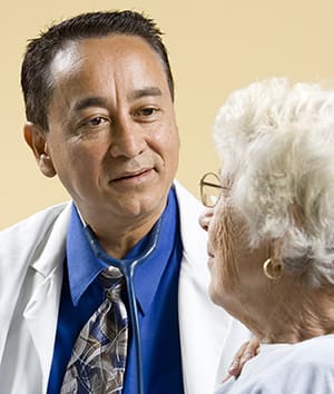 Doctor talking to elderly person.