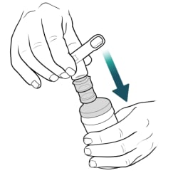 Hand pushing mouthpiece onto spout on top of medicine cup, with other hand holding bottom of cup.